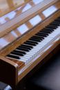 High angle of piano with reflective surface placed near seat for rehearsal at daytime