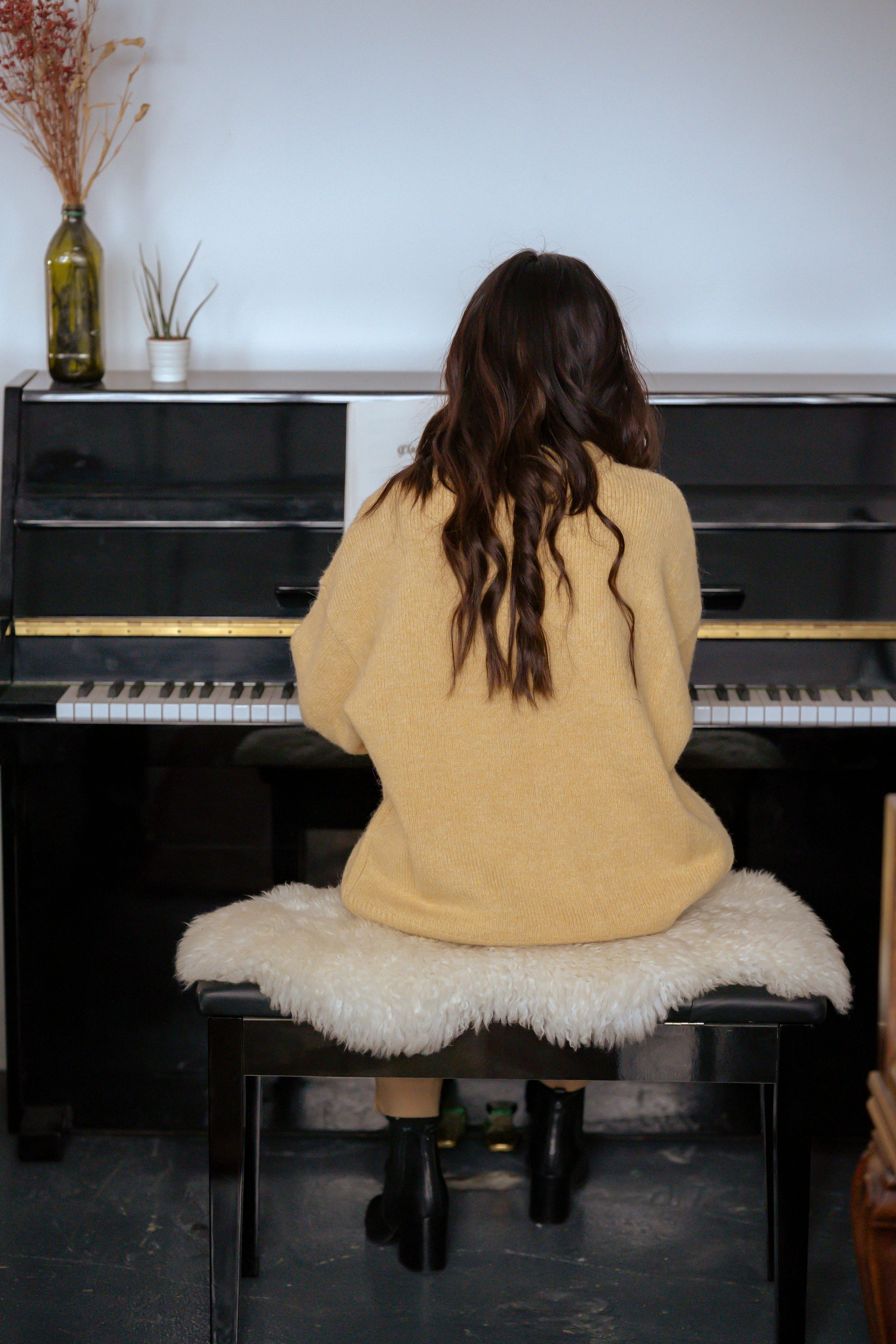 female musician playing piano during rehearsal