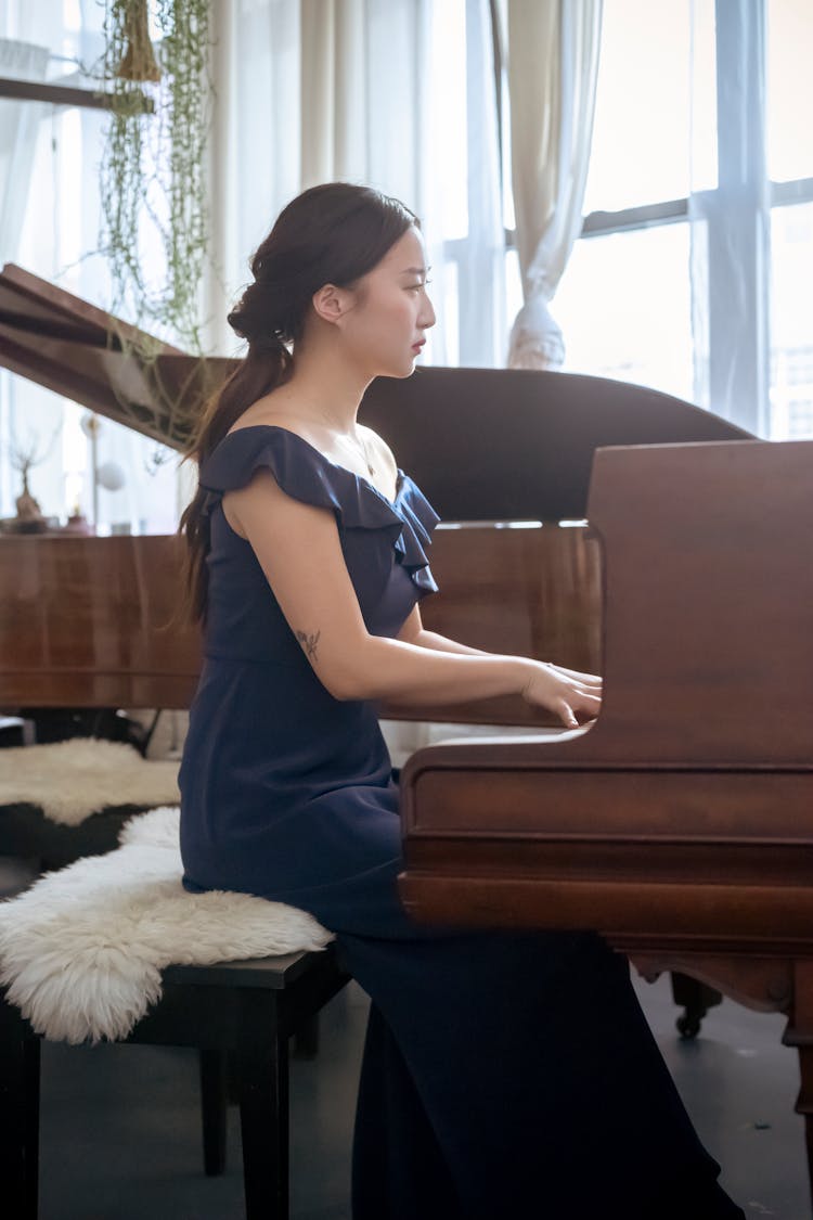 Elegant Asian Woman Playing Grand Piano