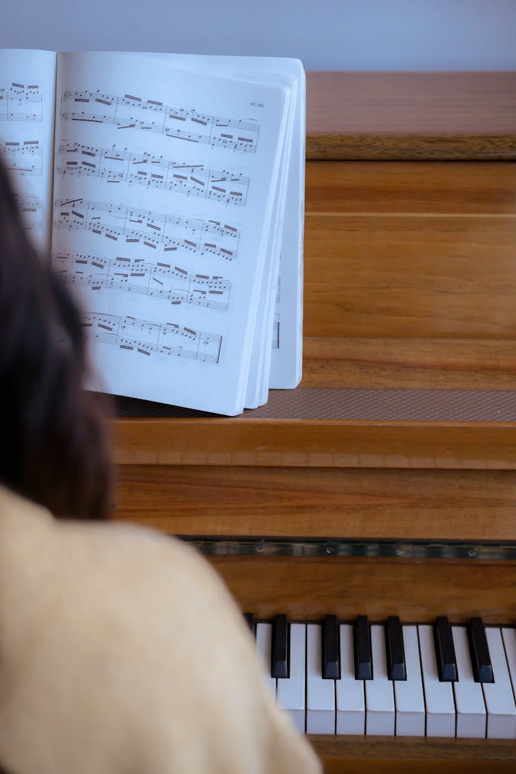 Faceless Woman Playing Piano In Studio