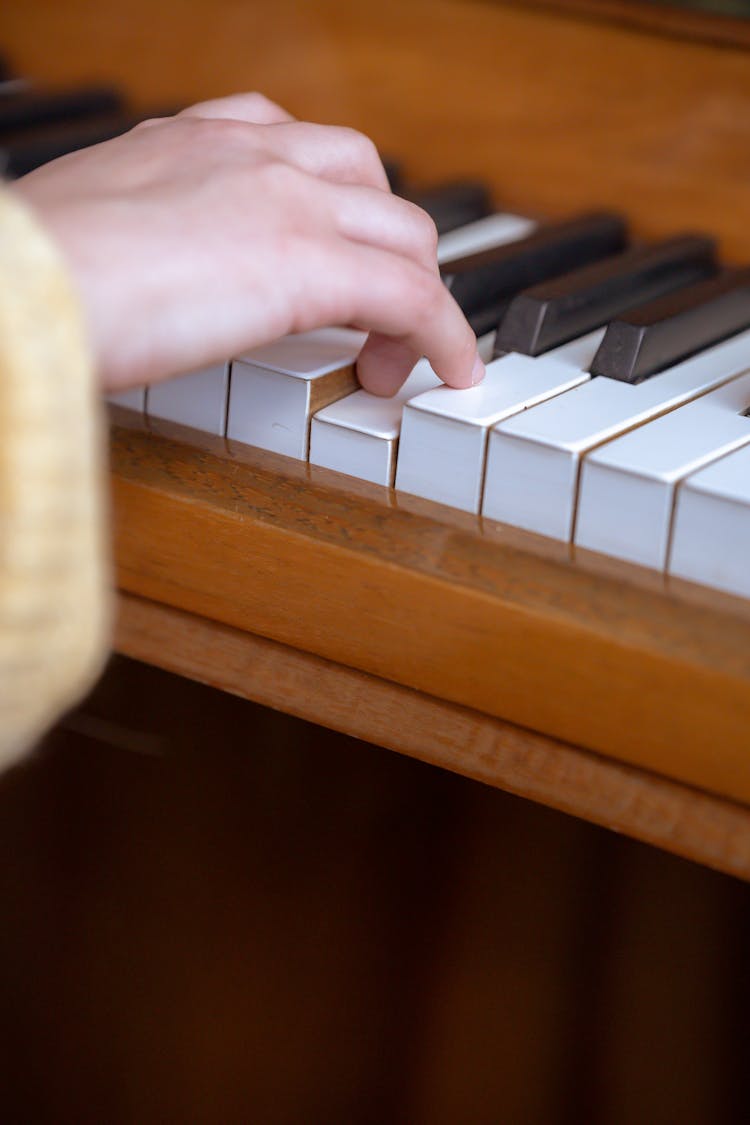 Faceless Woman Playing Piano In Studio