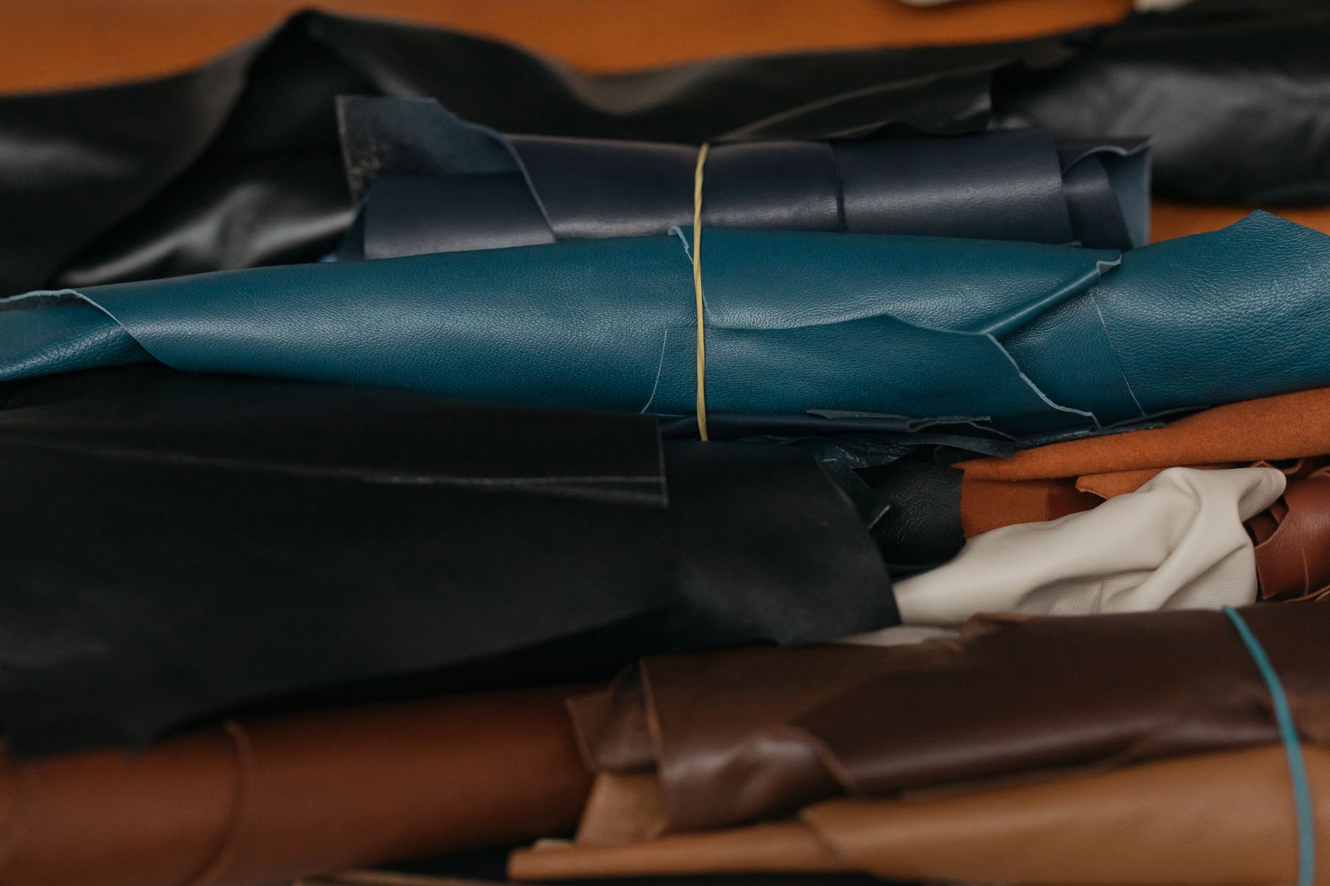 Close-up view of colorful leather rolls, perfect for crafting and textile production.