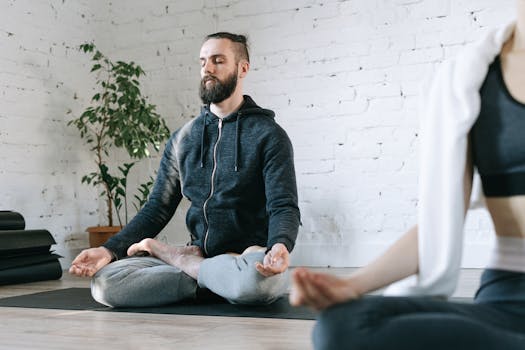 A man practicing yoga in a relaxed indoor setting, embodying calmness and mindfulness.