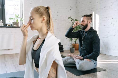 Free A Man and a Woman Doing Yoga Stock Photo