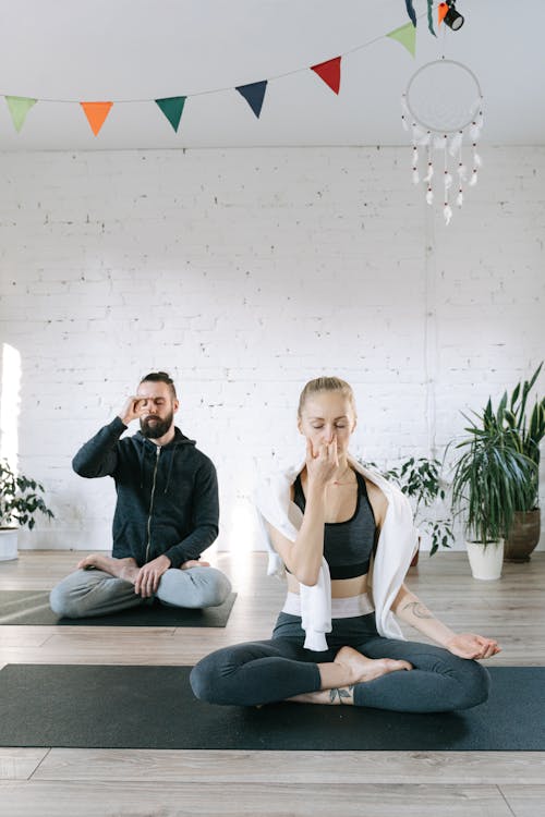 A Man and a Woman Breathing Control Exercise in Meditation