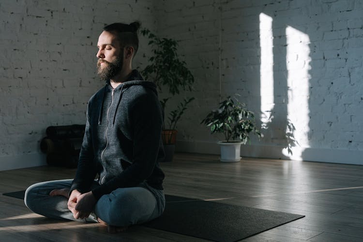 A Man Concentrating While Doing Yoga