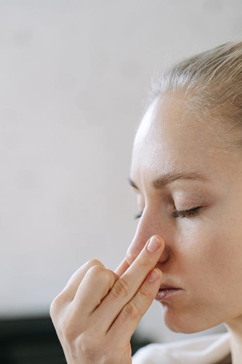 Close-Up Shot of Woman Touching her Nose