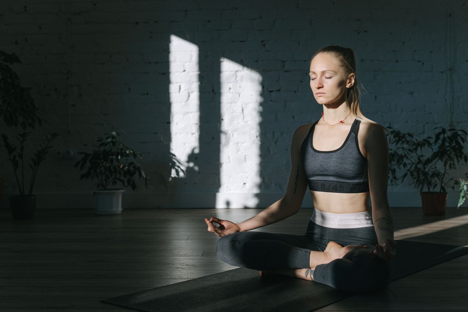 Woman meditating peacefully in a sunlit room practicing breathwork for depression