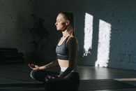A Woman Meditating while Doing Yoga