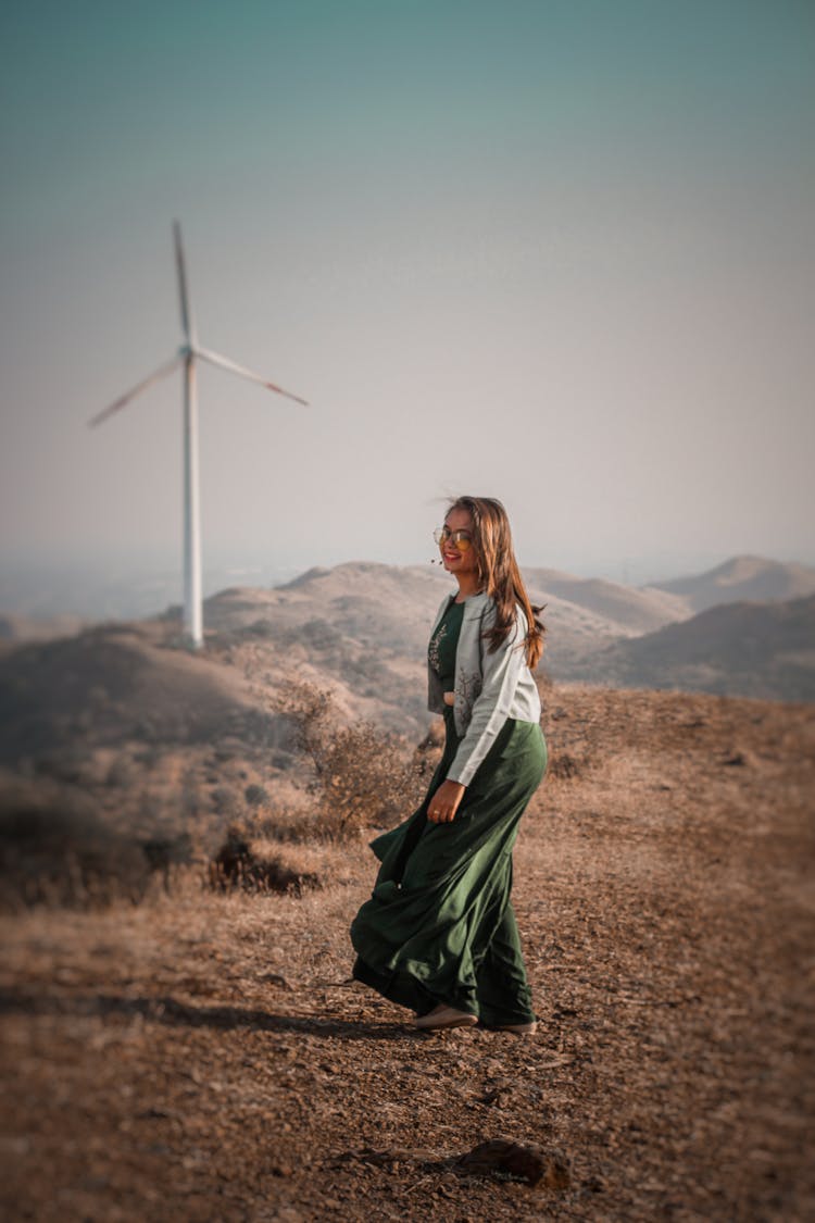 Stylish Woman Standing Near Wind Generator