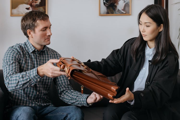 A Woman Looking A Leather Briefcase