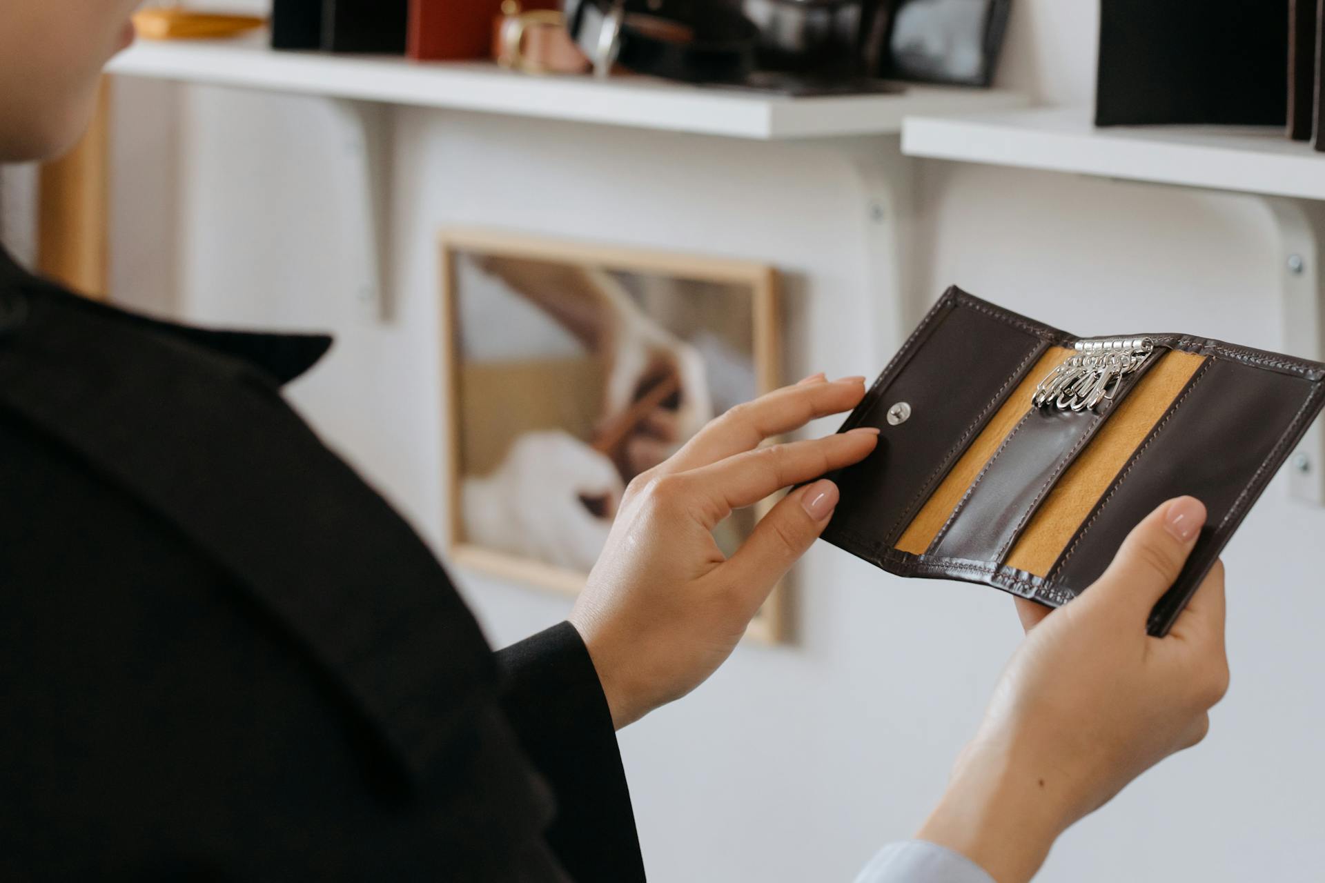 A Person Looking at a Leather Keyholder