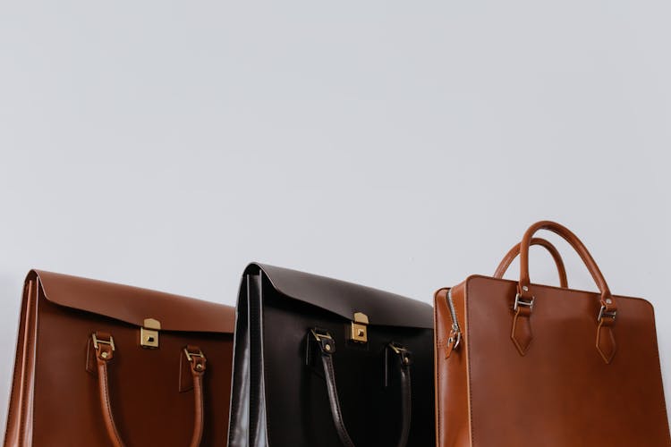 Brown And Black Leather Bags In Close-Up Photography