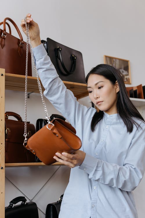 A Woman Holding a Brown Shoulder Bag