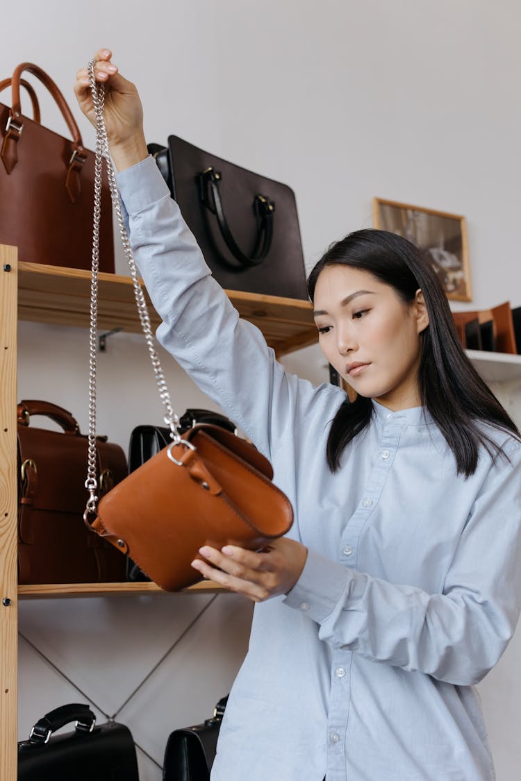 A Woman Holding A Brown Shoulder Bag