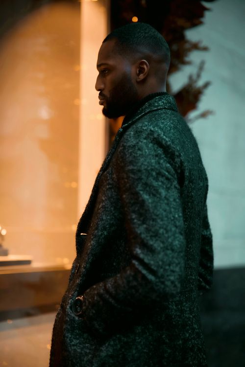 Free Close-up portrait of a stylish man in a gray coat standing outdoors in Ottawa, Canada. Stock Photo