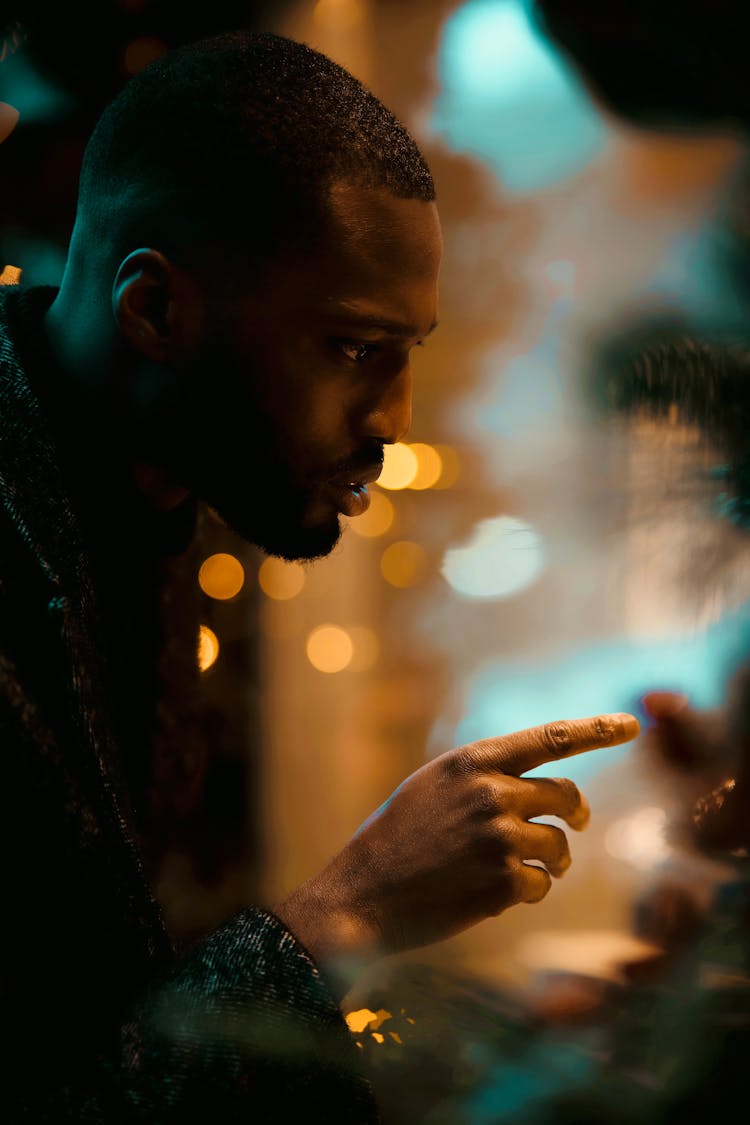 A Man Pointing His Finger At A Glass