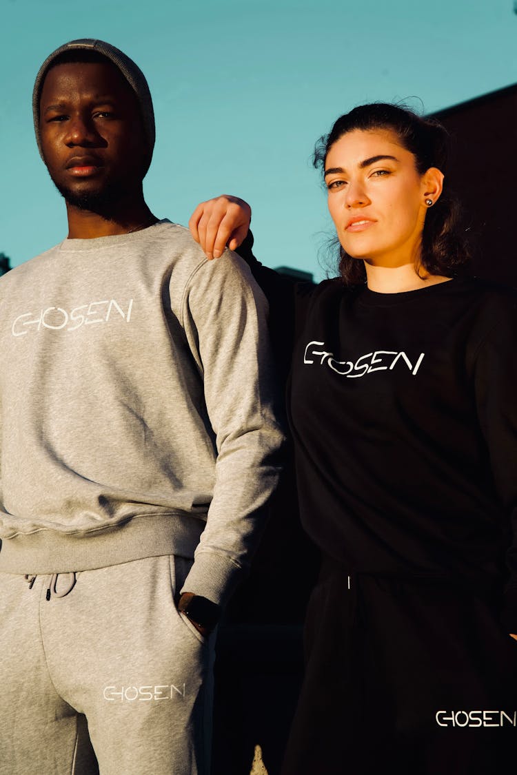 A Couple Wearing Chosen Brand Sweatshirts And Joggers