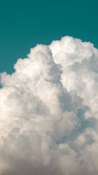 Beautiful cumulus clouds forming against a vivid blue sky.