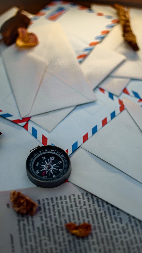 Free A Compass and Mail Envelopes on the Table Stock Photo
