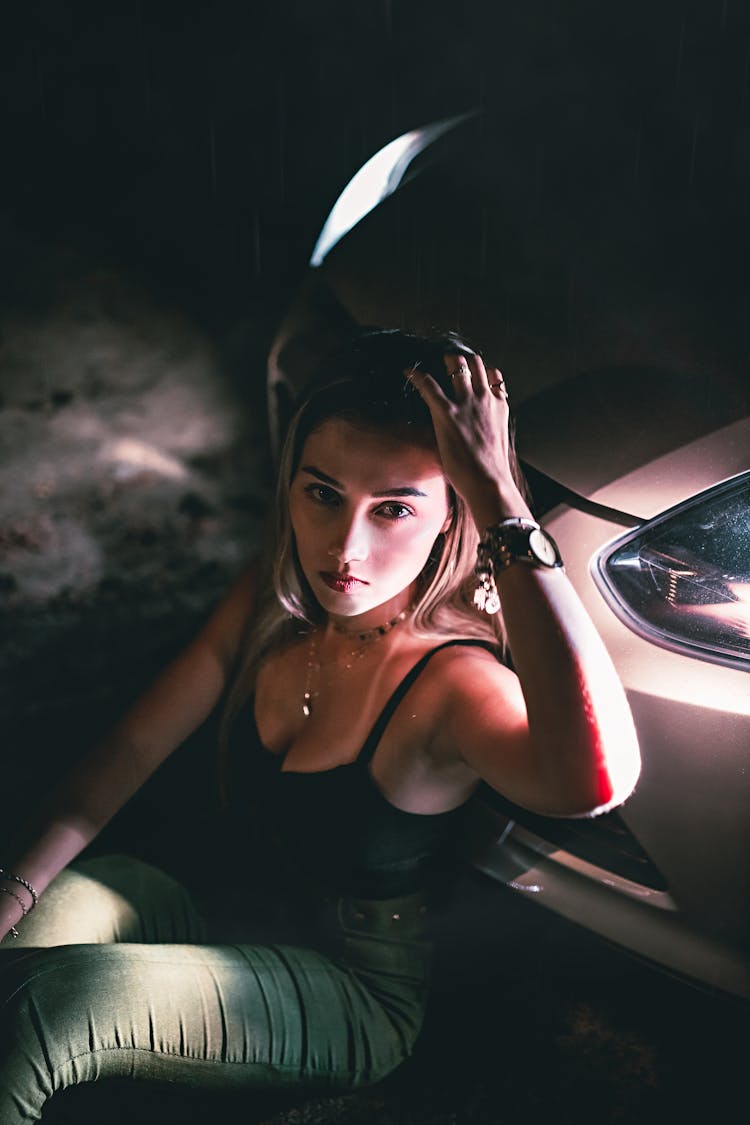 Young Woman Leaning On Expensive Silver Car