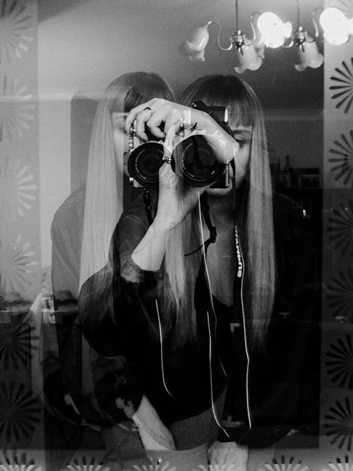 Free Grayscale Photo of a Woman Taking Picture Using a Camera Stock Photo