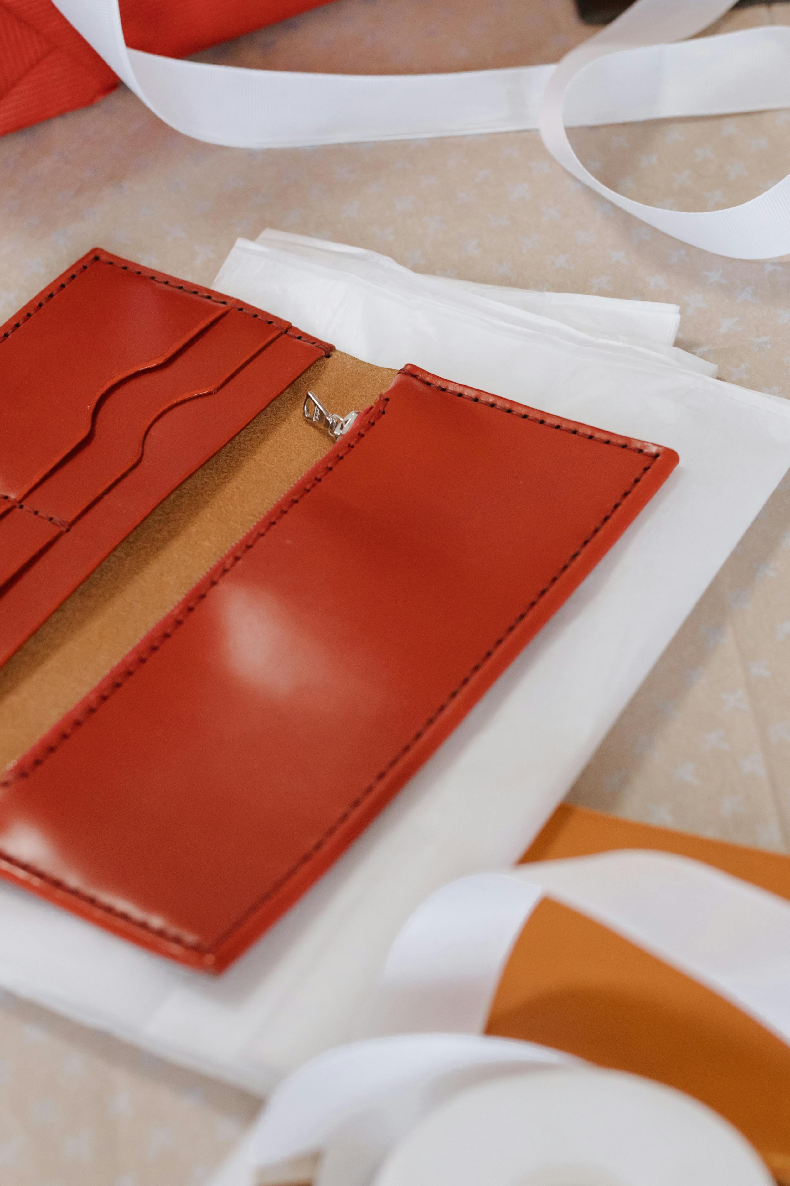 brown leather bifold wallet on white table