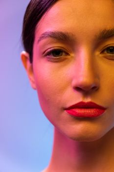 Artistic close-up portrait of a woman with dramatic lighting and bold red lipstick.
