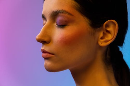 A Woman with a Blush On and and Eye Makeup