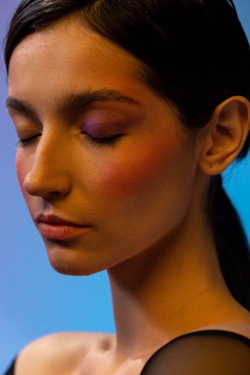 A Pretty Woman with Eye Shadow and Blush On in Close-up Photography