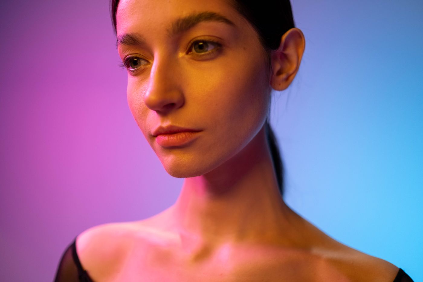 A person lit by pink and blue studio gels — photo by cottonbro studio on Pexels