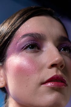 Elegant close-up portrait of a woman with glittery makeup and soft lighting.