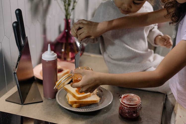 Mother And Daughter Making A Sandwich