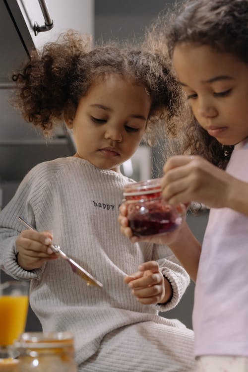 Free Kid Opening a Jar with Jam Stock Photo