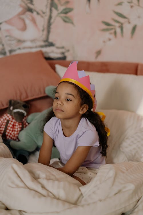 Free Girl Wearing Crown Sitting on Bed Stock Photo