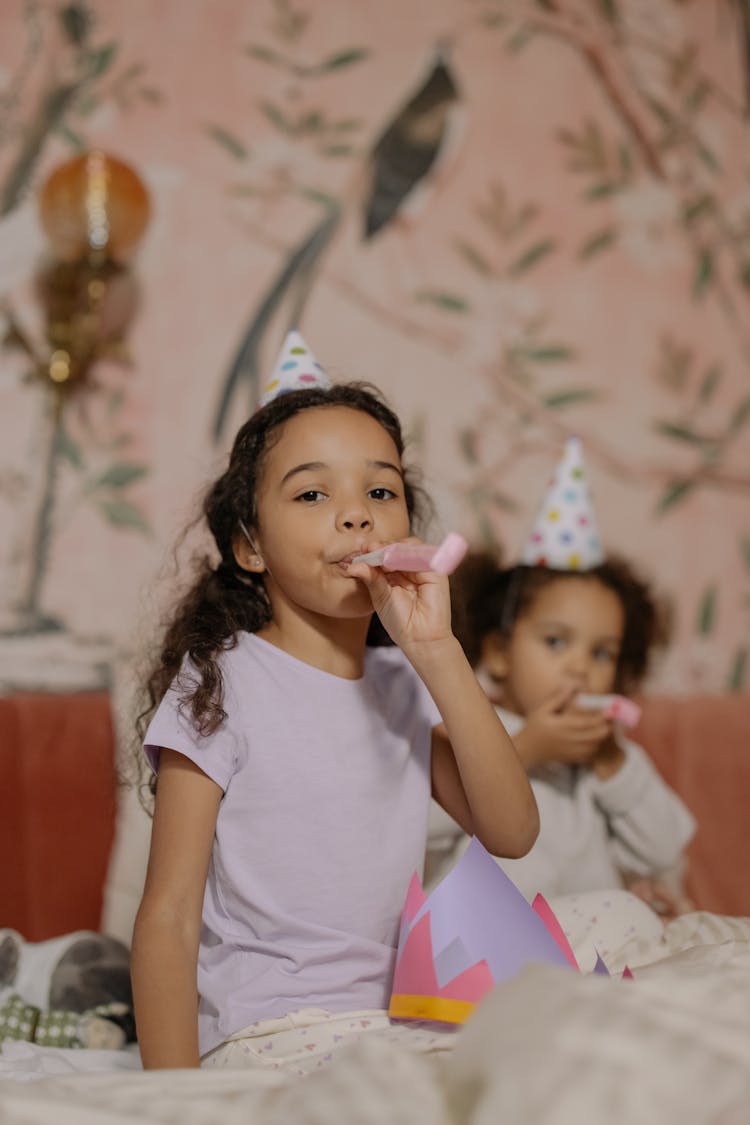 Kid Blowing A Party Horn