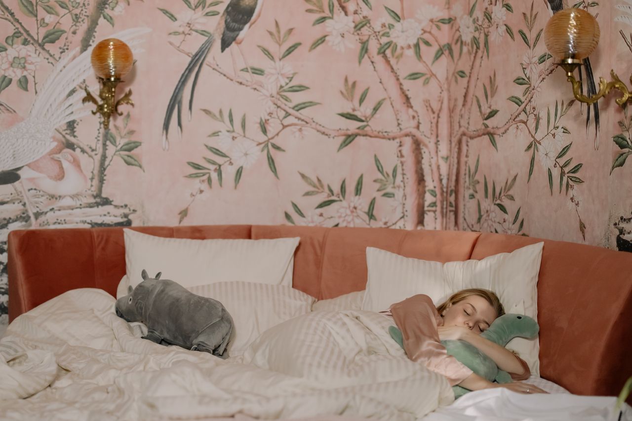 a child enjoying a peaceful nap with stuffed toys in a beautifully dec