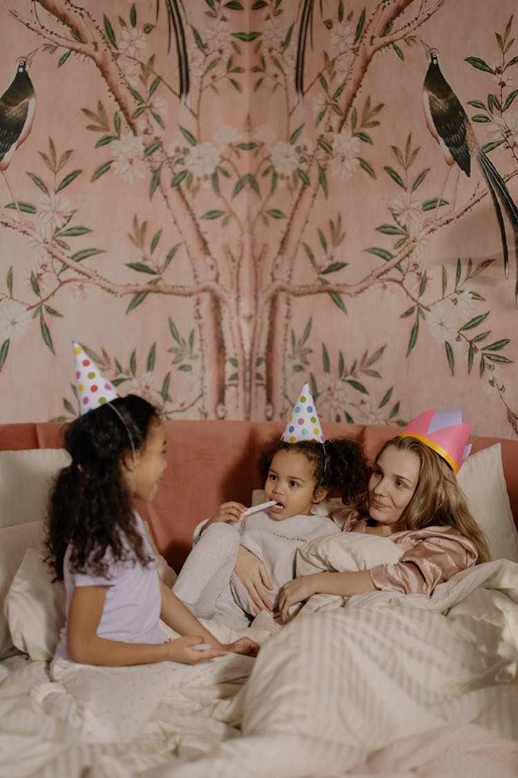 Girl Sitting On Bed While Talking To A Woman