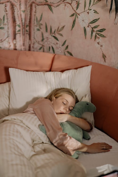 Free Woman hugging a Plush Toy While Sleeping Stock Photo
