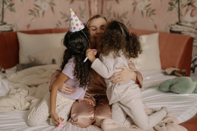 Photo Of Girls Kissing Their Mother