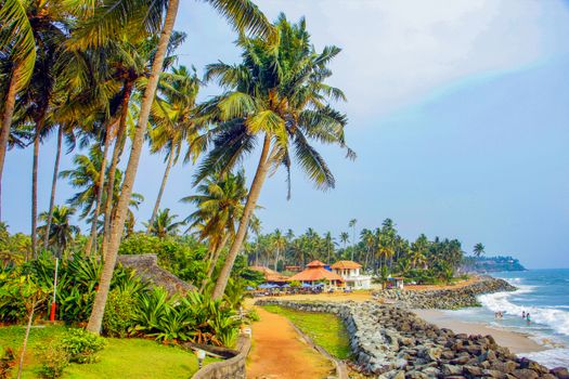 Idyllic tropical beach scene with palm trees and resort, perfect for a serene getaway.