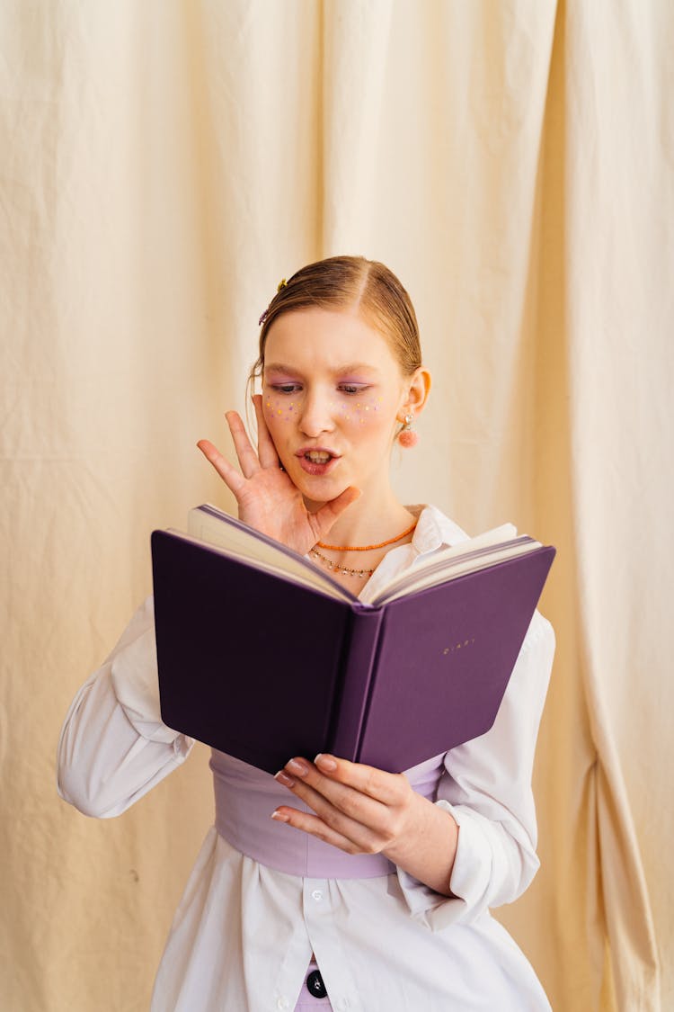 Girl Holding A Purple Book