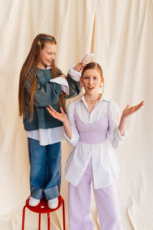 Girl Brushing Her Sister Hair