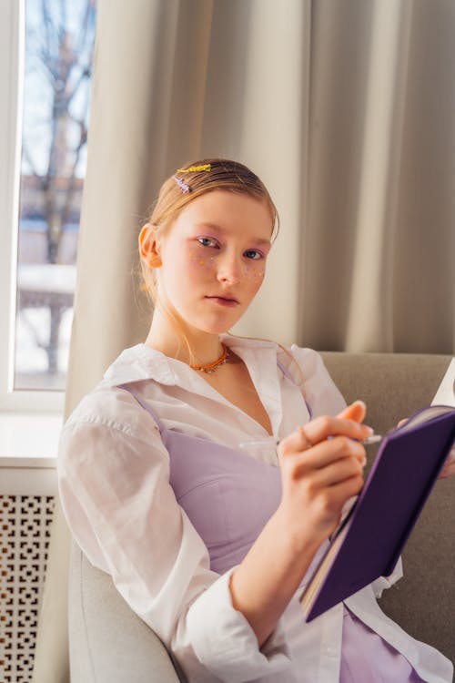 Teenage Girl Holding a Notebook