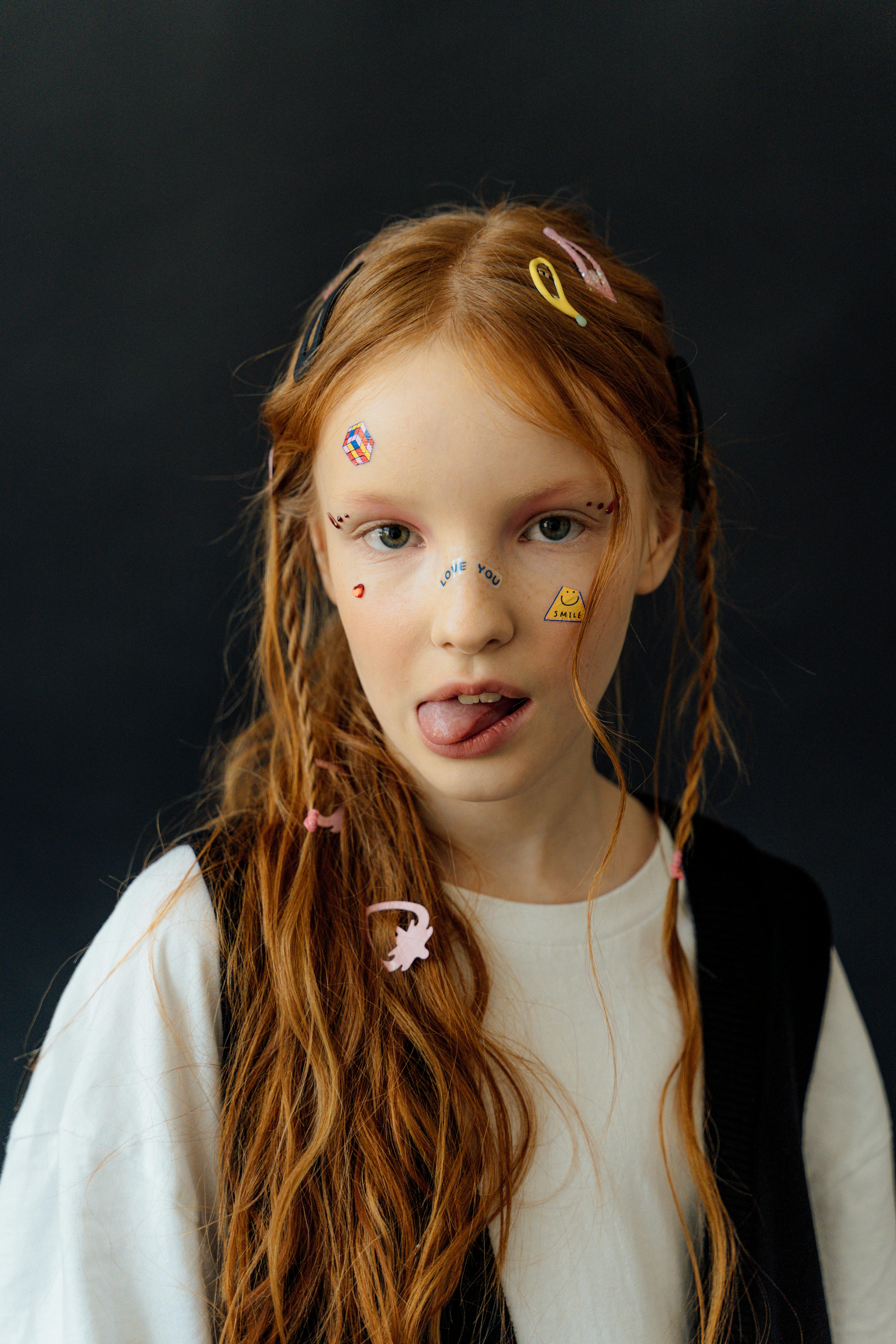 girl with stickers on her face