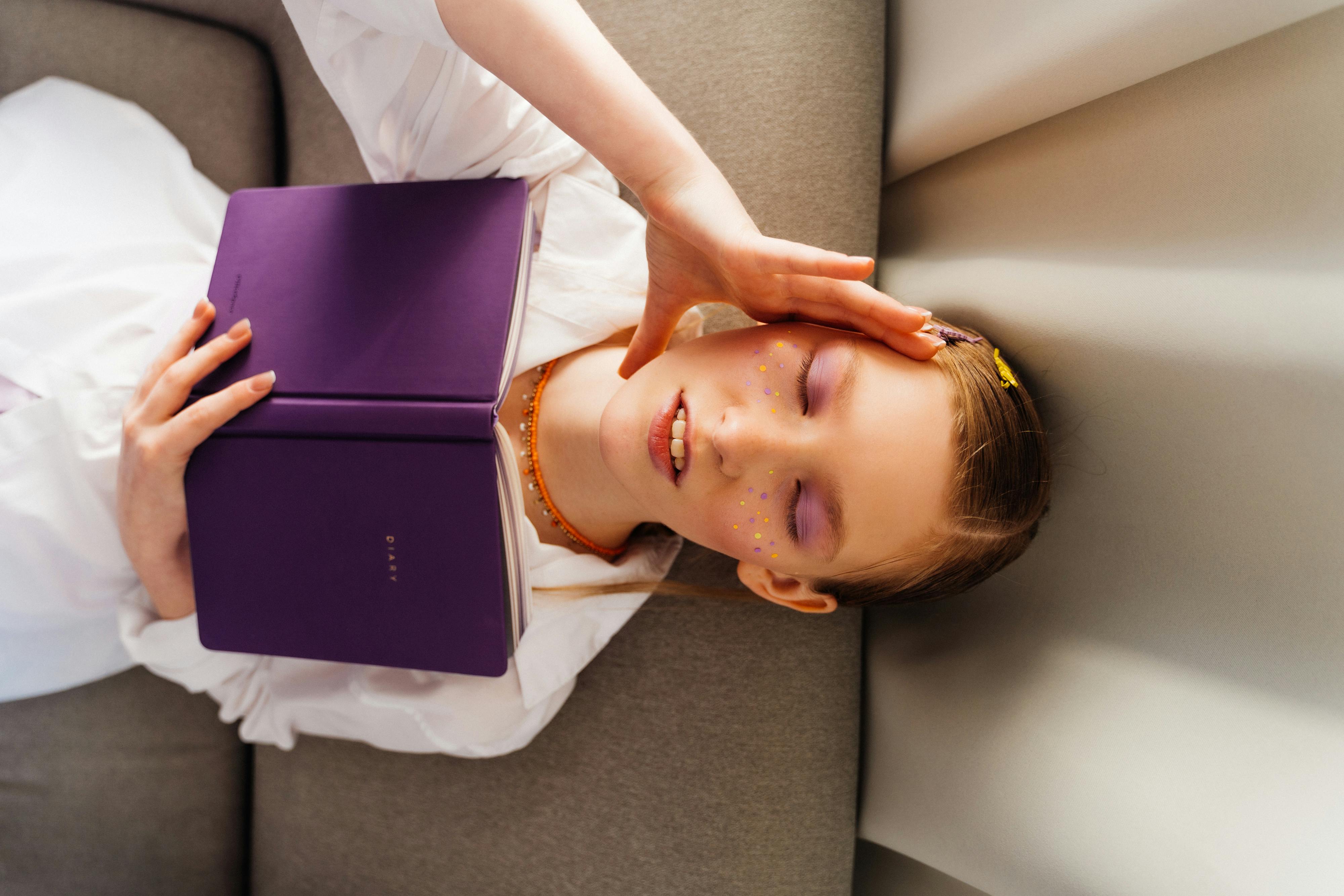 girl-reading-while-lying-down-free-stock-photo