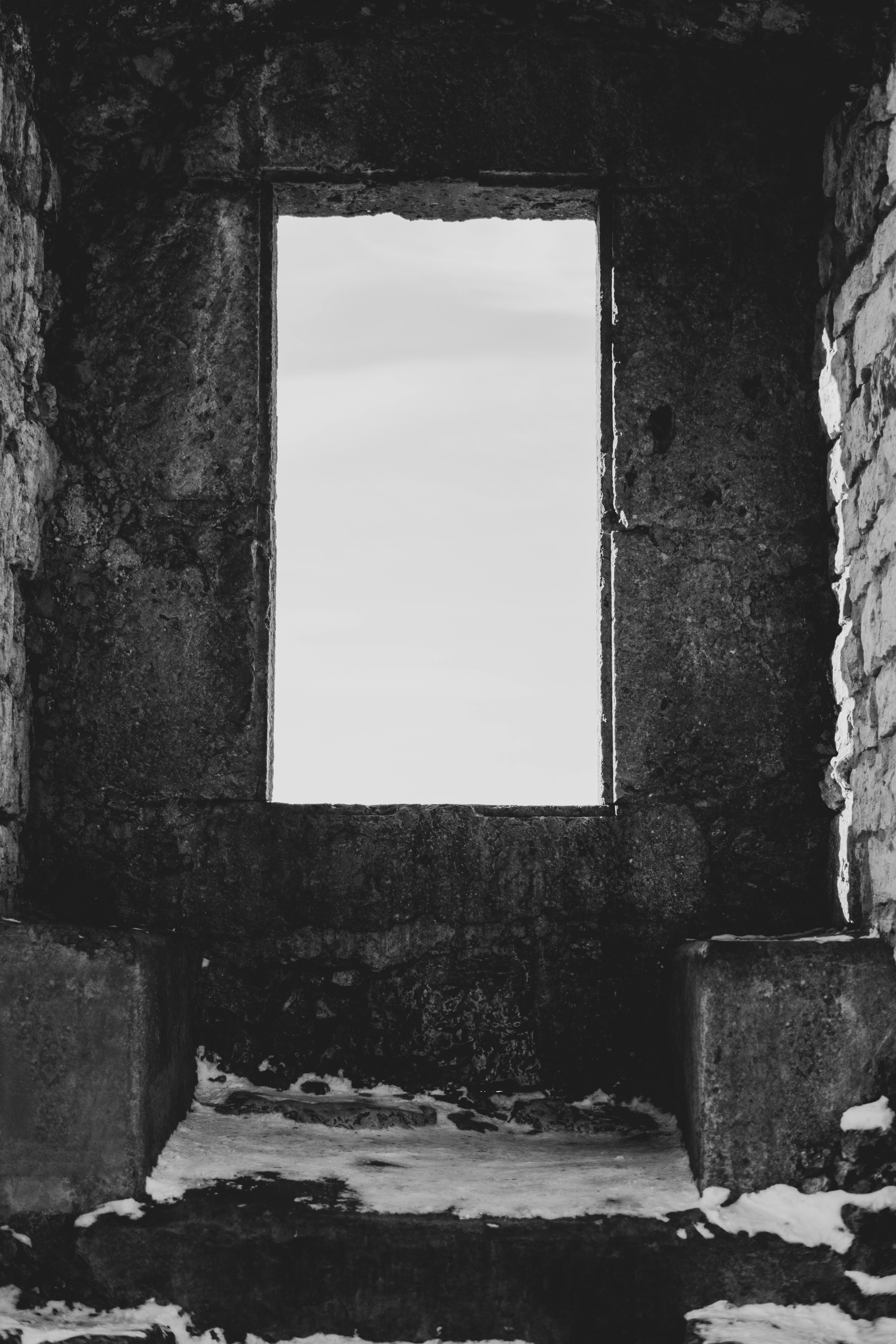 grayscale photo of a window of concrete structure