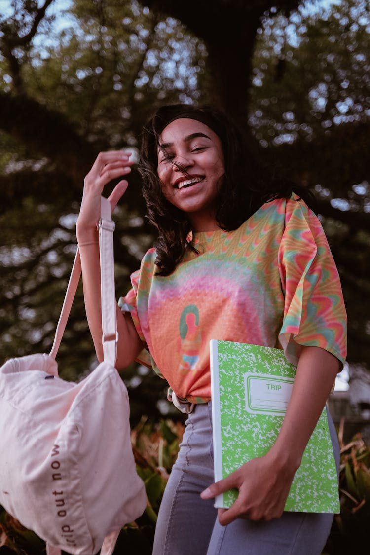 A Cheerful Young Woman In A Tie Dye Shirt