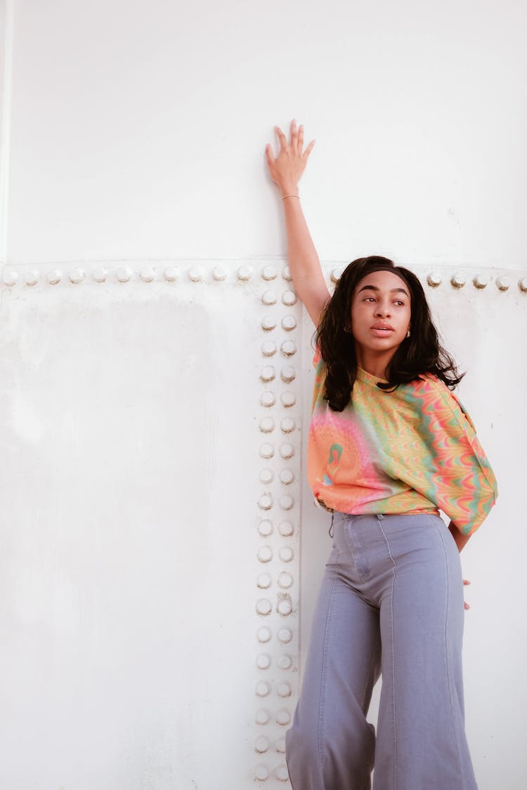 A Woman In A Tie Dye Shirt Posing