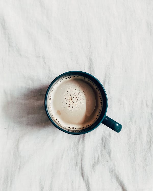 Cup of Coffee on White Surface · Free Stock Photo